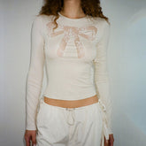 Top de encaje transparente con lazo Coquette
